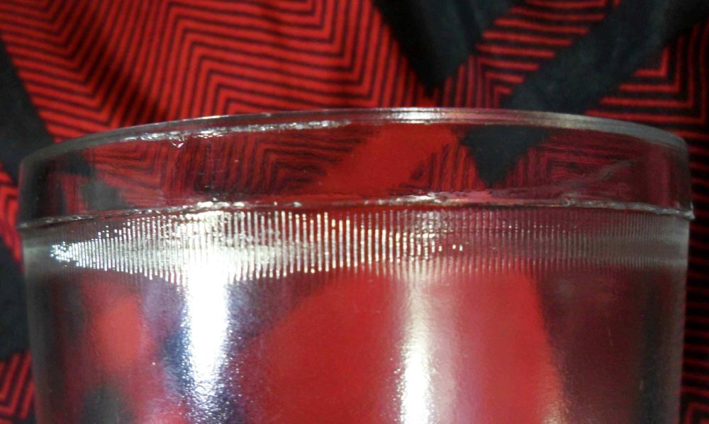 Closeup of "reeding" "knurling"  or "milling" effect below the top rim of Horseshoe and Star type jelly glass / tumbler.