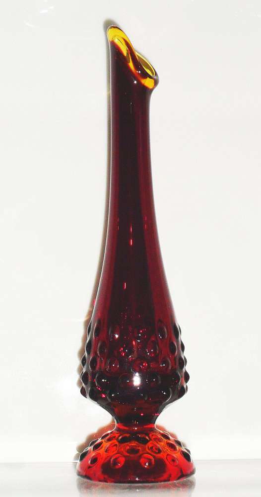 Ruby Red / amberina swung vase marked with "Fenton inside an oval" on the base. This is the smaller "bud vase" type. 