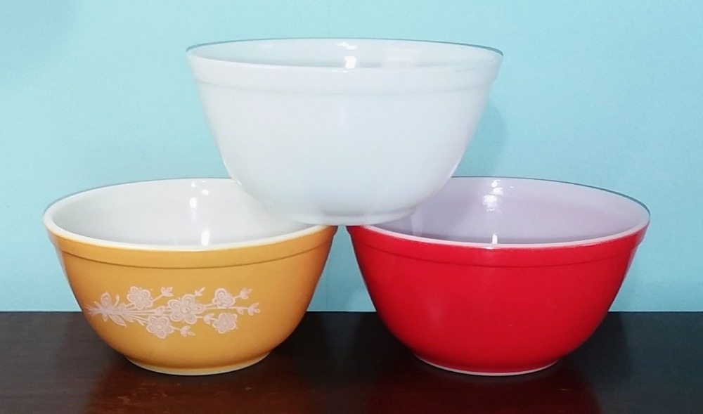 Three PYREX heat-resistant mixing bowls made by Corning Glass Works. All are marked with the style number "402" on the base --- Made by Corning Glass Works.