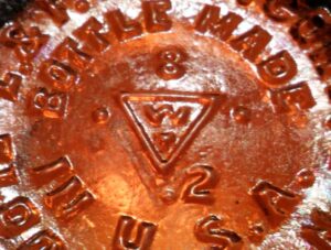 WT mark on base of small amber LYSOL bottle made by Whitall Tatum Company of Millville, New Jersey.