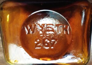 "WYETH" on base of amber medicine bottle.