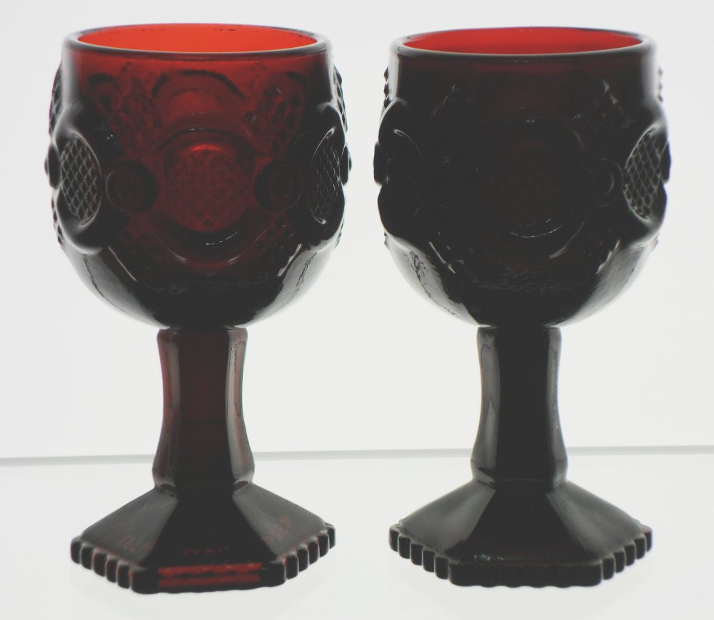 Pair of Avon "Cape Cod" pattern goblets in a dark ruby red glass. These items were evidently made by Wheaton Glass Company, although some MAY have been produced by Anchor Hocking Glass Corporation.