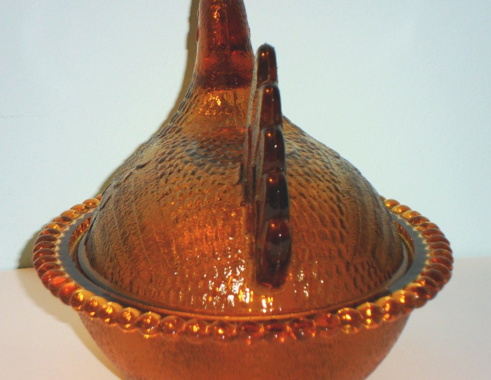 Indiana Glass hen in amber, showing tail view