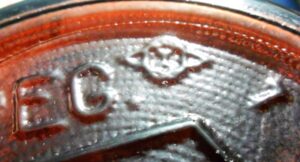 Diamond/oval/I mark used by Owens-Illinois Glass Company - on base of amber Clorox bleach bottle.