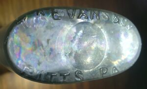 "T. A. EVANS &amp; Co / PITTS PA" on base of light aqua liquor flask (Photo courtesy of Jack Klotz).