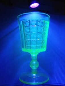 Two Panel goblet shown under black light, glowing a light bright yellowish green