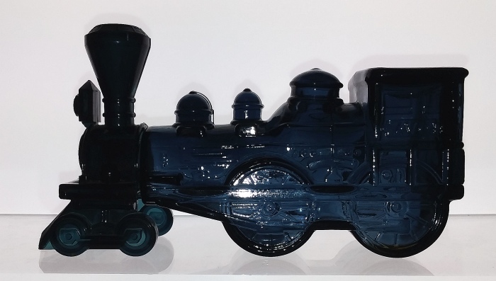 Dark slate blue "The General" Locomotive / train engine bottle, marked AVON.  This figural bottle (decanter) was issued circa 1970 and held Wild Country men's aftershave. The lid (front of the engine, to the left in this photo) is made of a dark blue plastic. 