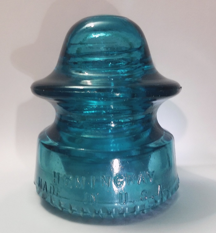 "Hemingray / Made in U.S.A. // No. 20" glass insulator in "Hemingray Blue". This shape is classified as a "CD 164" in the identification system used by collectors.