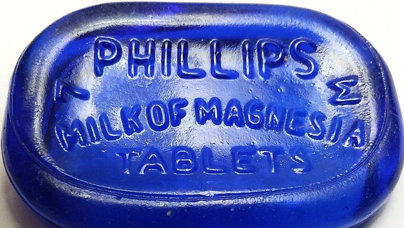 Phillips Milk of Magnesia Tablets- bottle base in cobalt blue - the sideways "M" on right indicating Maryland Glass Corporation. The "7" is a mold number. 