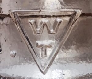 "W & T inside Triangle" mark, as seen on pinkish peach CD 154 glass electrical insulator made by Whitall Tatum Company, circa 1920s.