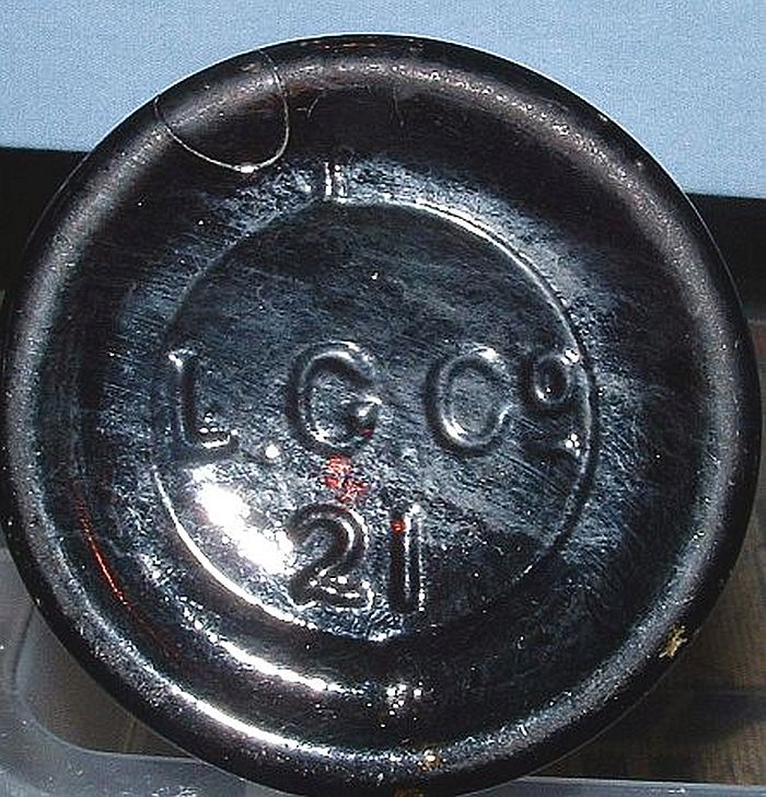 L.G.Co. mark as it appears on the base of an export-style dark amber beer bottle. This mark indicates production by the Lindell Glass Company of St. Louis, Missouri. 