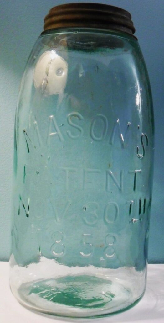 Typical aqua early handmade "Mason's Patent Nov 30th 1858" jar. This one is marked "W.C.D." on the base, and was made by W. C. DePauw Glass Co of New Albany, Indiana. 