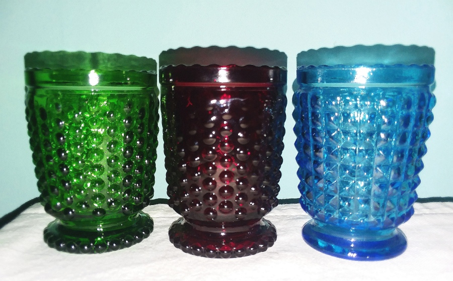 Three footed votive candle holders or toothpick holders - Green, blue and red. - unidentified glassmaker (so far).  Hobnail pattern on left two pieces, square pyramid type pattern on right.