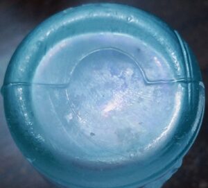 "Key Mold" type base, here as seen on aqua "Nerve and Bone Linament" antique glass bottle, circa 1860s.