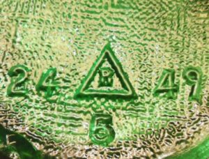 "R in a triangle" mark used by Reed Glass Company. This bottle base has 1949 date code to the right of the logo.