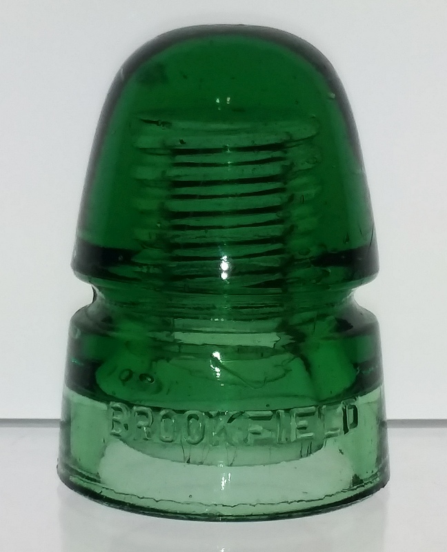 CD 145 "beehive" style green glass telegraph line insulator, made by Brookfield Glass Company. Brookfield operated at Brooklyn, NY and Old Bridge, NJ. This example probably dates from sometime in the 1900-1920 time period. 