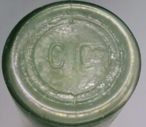 "C C" on base of green glass cylindrical pickle or "Chow Chow" jar/bottle,  circa 1870s-1900 and almost certainly from Great Britain.  The mark is unidentified.