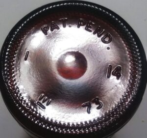 Midland Glass "Stylized M" logo (lower left) on bottom of "Stubby" amber beer bottle made in 1973.