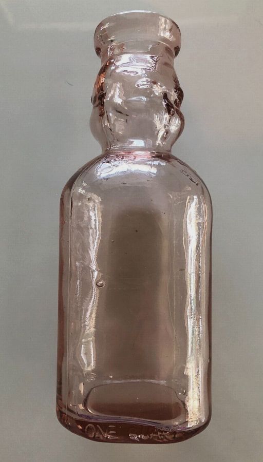 Pink glass BROOKFIELD "Baby Face" milk bottle. This type is a later reproduction bottle. (Virtually all authentic Brookfield milk bottles are clear glass). (Photo courtesy of Worthpoint/eBay -unidentified seller).