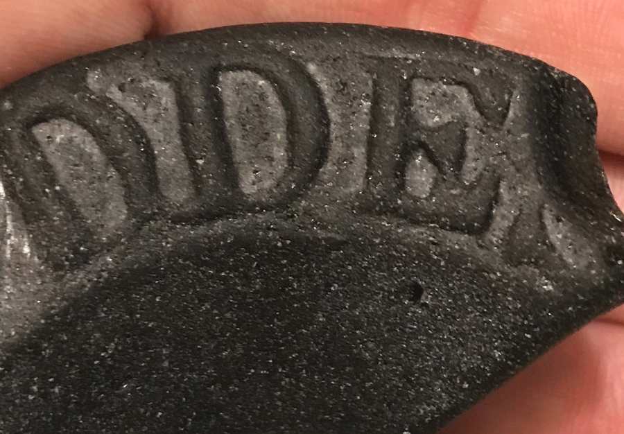 DDES - partial lettering on black glass Beach Glass (unidentified bottle base)  - possibly circa 1840s-1870s.  (Photo courtesy of Kelly)