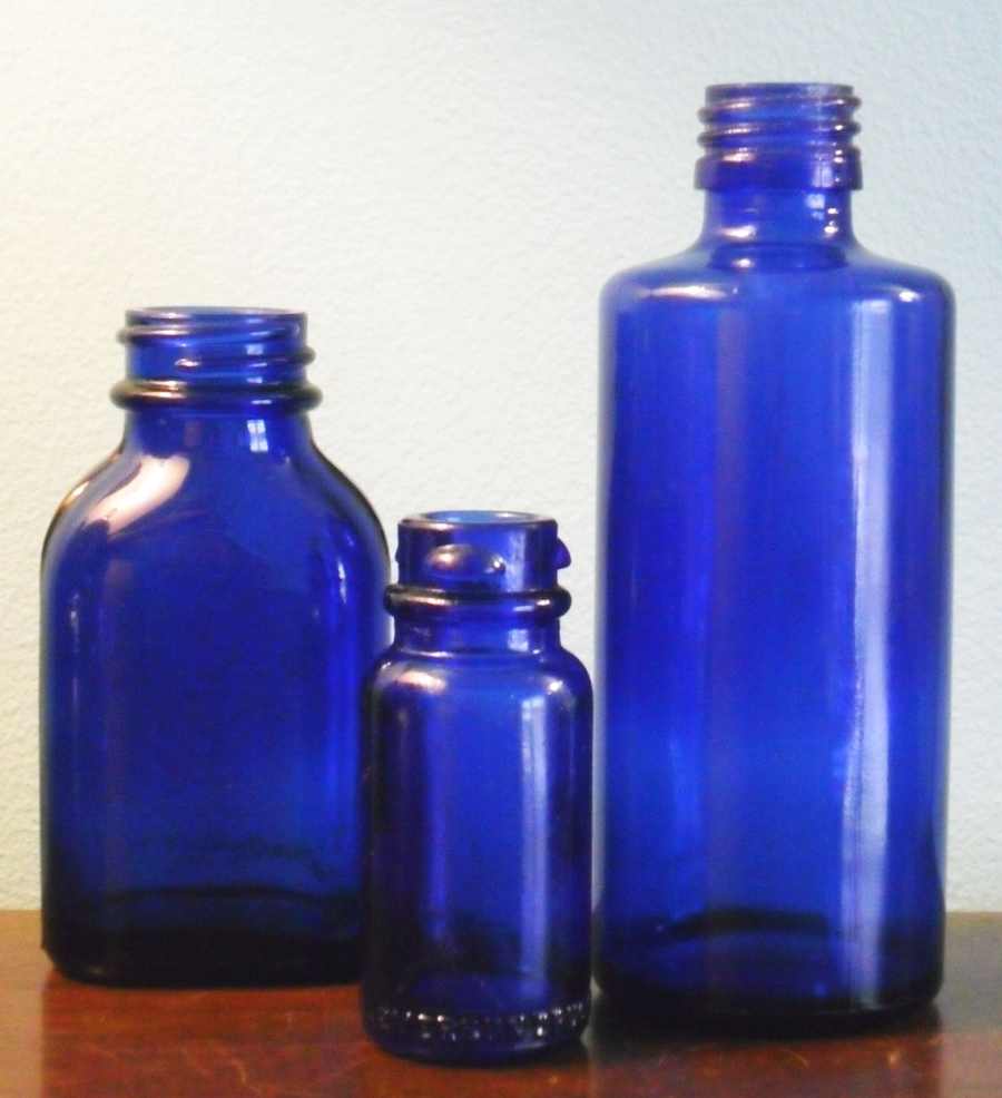 Maryland Glass Corporation bottles: (Left to right) marked "Phillips Milk of Magnesia Tablets" with an "M"; Bromo-Seltzer Emerson Drug Co. bottle with "M in a circle / 24" on base; plain blue medicine/chemical bottle with "M in a circle / 7" on base.