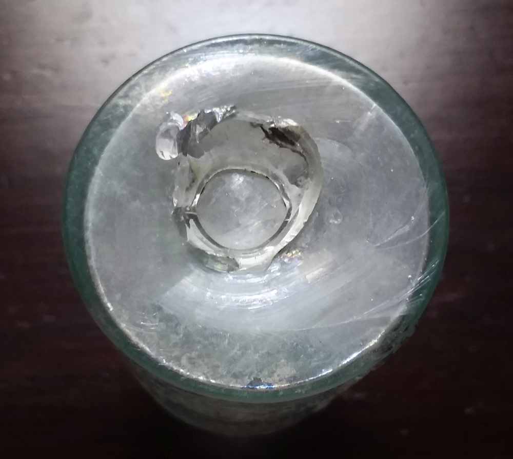 "OPEN PONTIL" scar on the base of a light aqua "SPALDING'S GLUE" bottle, probably circa 1840s-1850s era. 