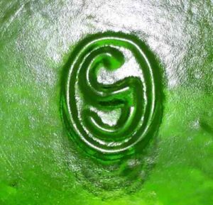 "G inside an oval" trademark used by Gallo Glass Company, Modesto, California, on base of green wine bottle.