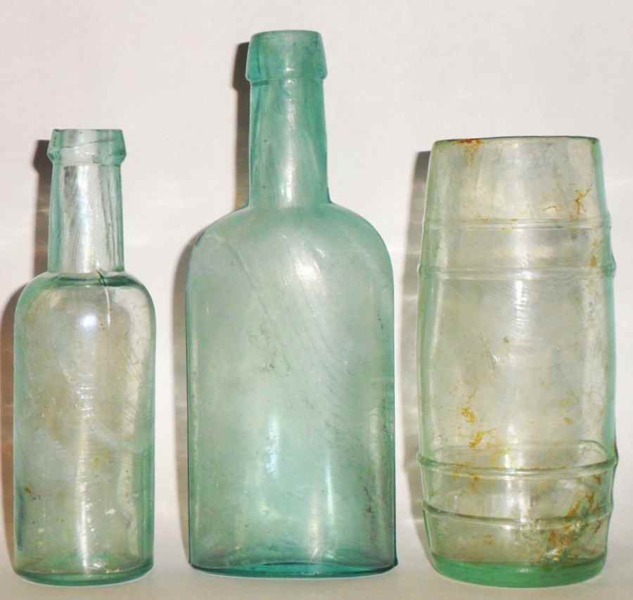 Great Western Glass Company bottles (left to right, round castor oil; oval "Jamaica Ginger" or bluing bottle; mustard barrel - all marked "G W" on bases).