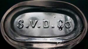 "S.V.D.Co." mark on base of clear mouthblown druggist bottle - The initials almost certainly stand for Saginaw Valley Drug Company of Saginaw, Michigan, circa 1899- c. 1915 or later. 