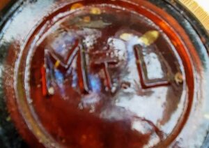 MT.L. mark on base of amber beer or soda bottle. (Photo courtesy of Seth Miller)