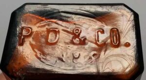 P. D. & CO. - initials on base of mouthblown Parke Davis &amp; Company rectangular amber "Blake" style glass druggist bottle.