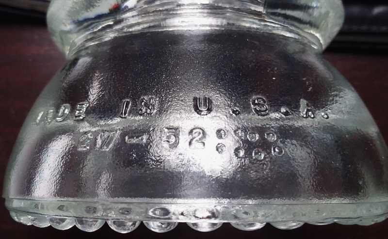 1960 date code on skirt of clear glass Hemingray-42 insulator: The "27" is the mold number, "52" is the year the mold itself was made, and the presence of the eight dots indicate the insulator was made in 1960. 1960 date code on skirt of clear glass Hemingray-42 insulator: The "27" is the mold number, "52" is the year the mold itself was made, and the presence of the eight dots indicate the insulator was made in 1960.