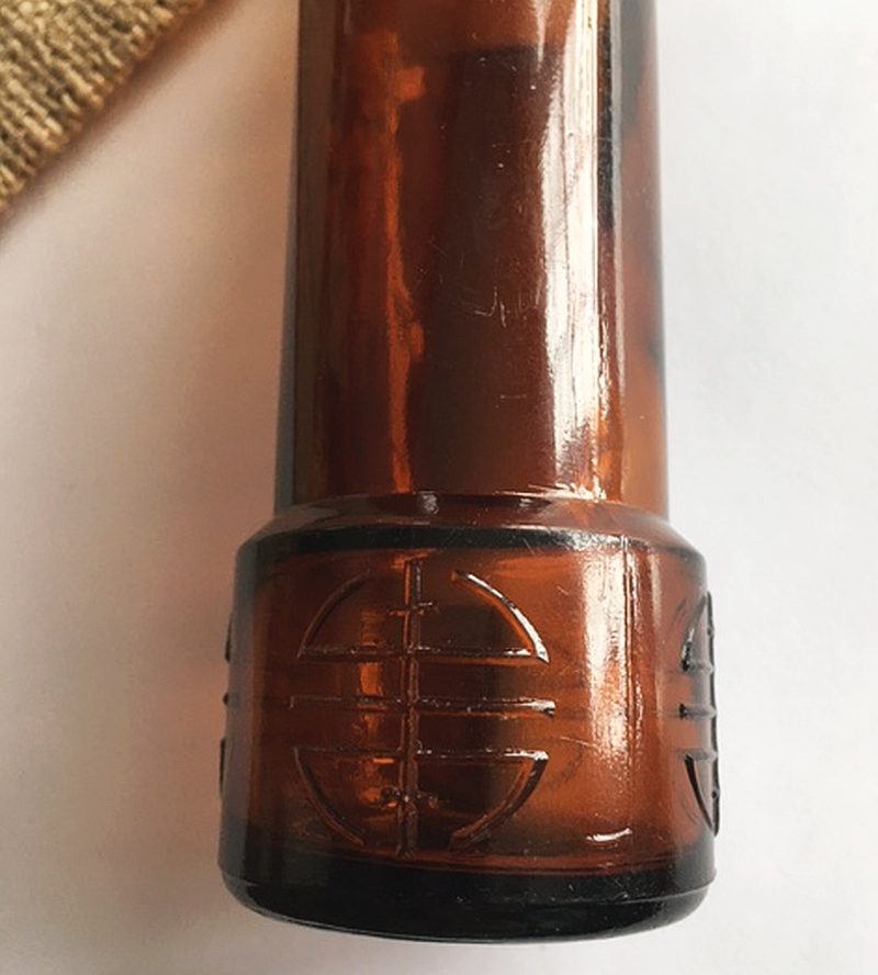 Lower heel portion of amber glass telescope bottle made by Fairmount Glass Works - Photo courtesy of Jane Roth.