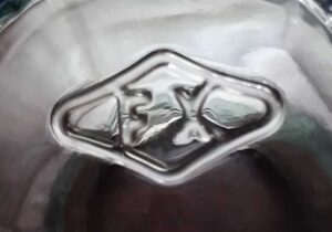"FX in a diamond" mark - on base of small clear glass jar or shaker. 