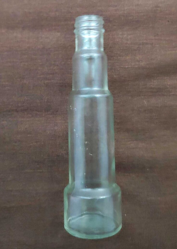 Off-clear or very light green telescope-shaped bottle made by Glass Containers Corporation (3173 mold style number). (Photo courtesy of Parker Kolb). Off-clear or very light green telescope-shaped bottle made by Glass Containers Corporation (3173 mold style number). (Photo courtesy of Parker Kolb).