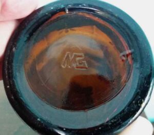 "MG-connected" mark on the base of amber hand-painted bottle made by Maywood Glass Company (above).