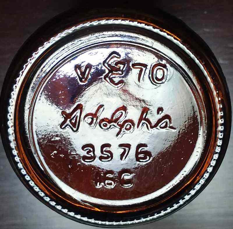 Angular GC mark used by Glass Containers, Inc. as seen on base of amber ADOLPH'S meat tenderizer jar, with 1970 date code. The "V" left of logo may be a plant code number for the Vernon, California factory. "3576" is the bottle design (style) number. "16C" is a mold cavity number. Angular GC mark used by Glass Containers, Inc. as seen on base of amber ADOLPH'S meat tenderizer jar, with 1970 date code. The "V" left of logo may be a plant code number for the Vernon, California factory. "3576" is the bottle design (style) number. "16C" is a mold cavity number.