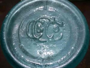 C C & Co (monogram) on base of light bluish-aqua Carl Conrad and Company beer bottle made for Anheuser-Busch Brewing Company.