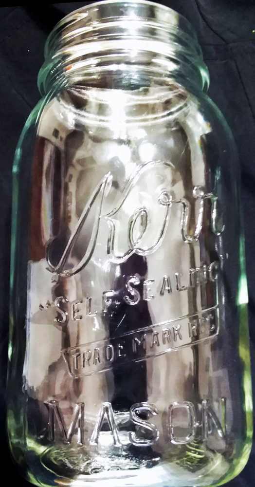 Kerr Self-Sealing Mason jar in clear glass. This particular variant is marked with the AHK initials on the base and probably dates from the 1970s. Kerr Self-Sealing Mason fruit jar in clear glass. This particular variant is marked with the AHK initials on the base and probably dates from the 1970s. (Clear glass is notoriously hard to photograph and I have this placed in front of a dark background)