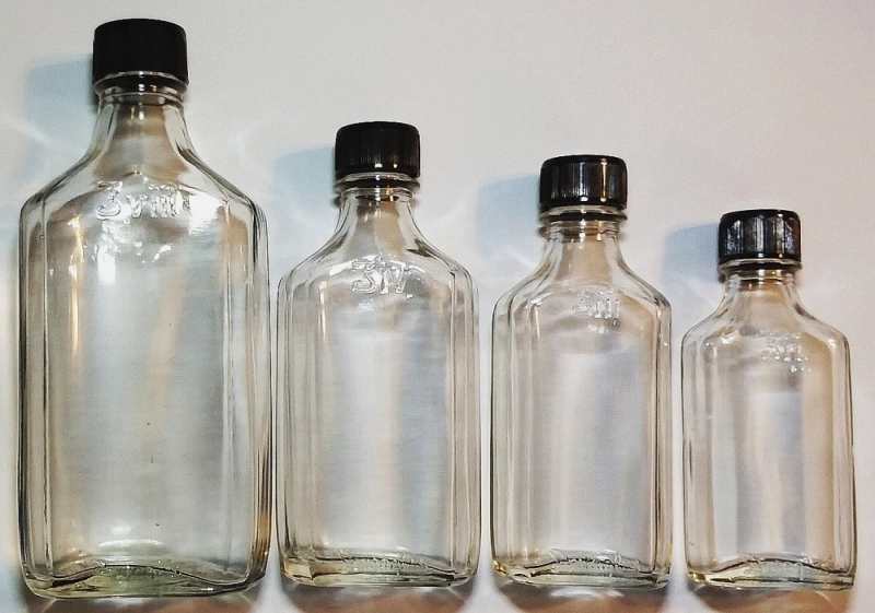 Group of four medicine bottles bearing the "Duraglas" marking on both the front heel and the base. These are marked with the "weird 3" logo (standing for "ounce"), so these bottles held, from left to right, 8 ounces, 4 ounces, three ounces and 2 ounces. They date from the 1940s or 1950s. 