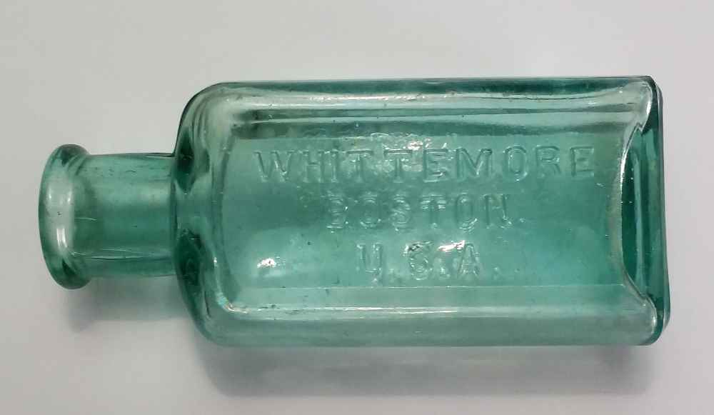 "Whittemore Boston U.S.A." shoe polish bottle in a medium green-aqua colored glass. This size held five ounces and probably dates from the 1880s or 1890s.
