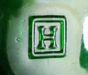 "H in a square" trademark as it appears on the base of an emerald green beer or soda bottle made by Hemingray Glass Company, Muncie, Indiana in the 1924-1935 period. "H in a square" trademark as it appears on the base of an emerald green beer or soda bottle made by Hemingray Glass Company, Muncie, Indiana in the 1924-1935 period.