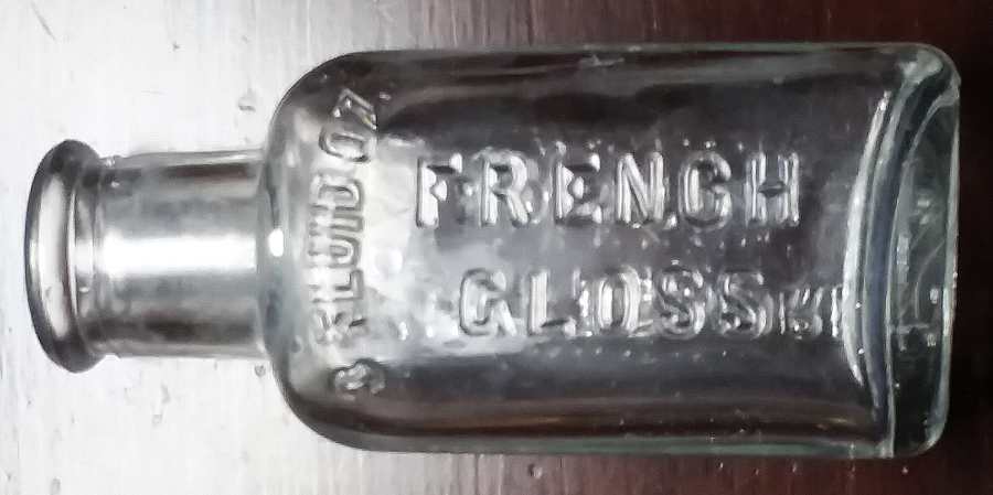 Three ounce size bottle marked  "Whittemore Boston  //  3 FLUID OZ. / French Gloss" -  clear glass, machine-made.  This type is one of the most recent variants, and probably dates from sometime in the 1930s-1940s.  It bears an Owens scar on the base but no glassmaker mark.