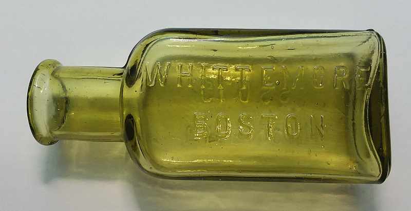 Antique Whittemore Shoe Polish bottle in Citron colored glass,  tooled lip, probably from the 1890s or 1900s. This type is marked "WHITTEMORE / BOSTON" on the front and "FRENCH / GLOSS" on the reverse. This size held three ounces liquid.