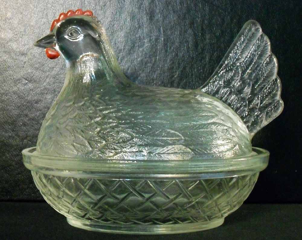 Small hen on nest dish, formerly believed to have been made by Indiana Glass Company, now known as a Hocking Glass Company product. Small hen formerly believed to have been made by Indiana Glass. Evidently a product of Hocking Glass Company.