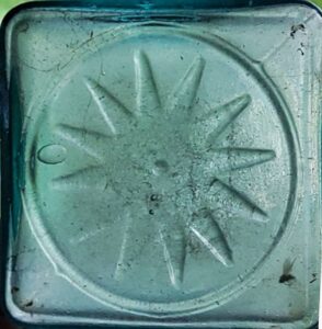 12-point "STAR" or rayed "SUN" mark on base of rolled lip crude aqua pickle bottle - uncertain glassmaker (Photo courtesy of eBay seller pujo1965 "The Best Bottle Shop"). 