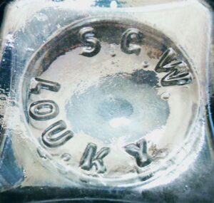 "S.G.W. LOU. KY" on base of small aqua pickle bottle (perhaps meant for horseradish).