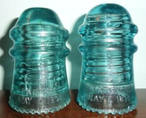Two Hemingray No. 9 insulator "Script" examples (rear skirt- dated side)