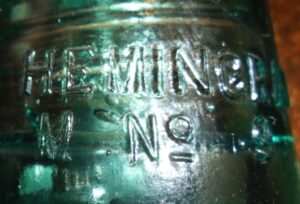 "M to left of No. 9" error mold on Hemingray No. 9 glass telephone line insulator.