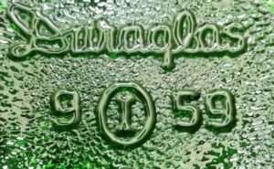 "I inside of an O" trademark/logo - Owens-Illinois Glass Company "I inside an O" trademark used by Owens-Illinois, here on the base of a Seven-Up soda bottle, made in 1959 at their Streator, IL factory (plant #9).